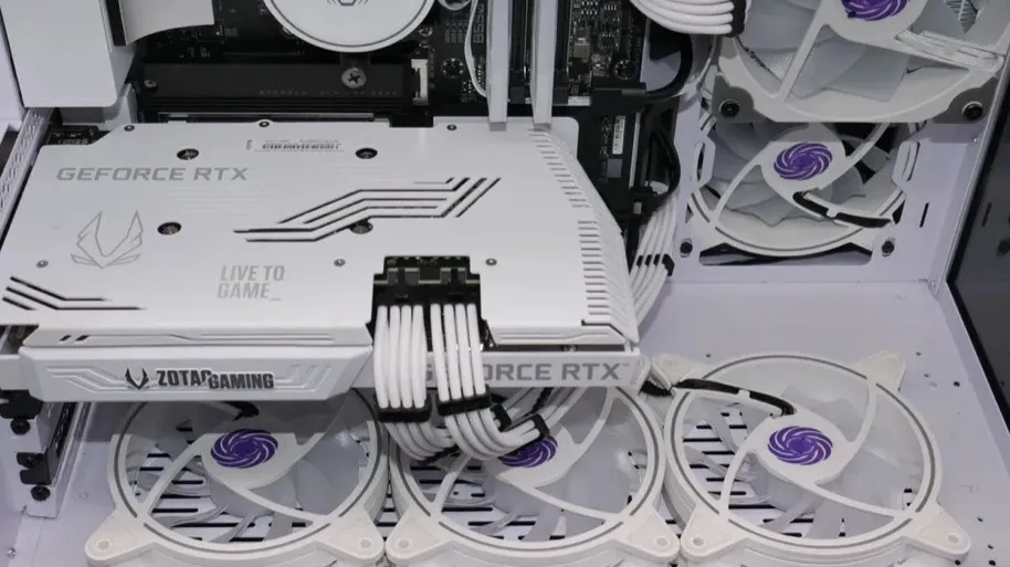 Top-down detail of a completed white gaming PC with custom cable routing